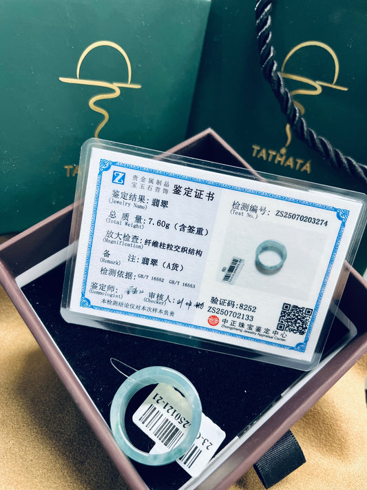 A certified Type A natural jadeite ring presented with an official gemstone certificate, inside a TATHATĀ jewelry box that reflects the brand’s commitment to authenticity and quality.