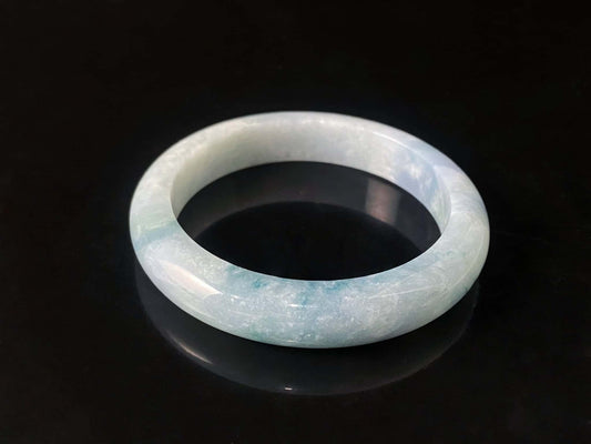 A sky blue cloud jadeite bangle.