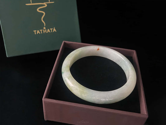A milky mint honey spot jadeite bangle.