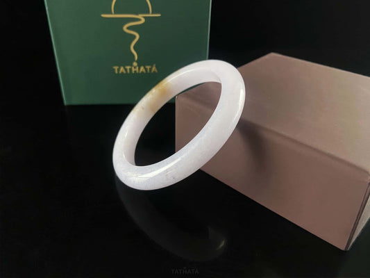 A lavender golden tip jadeite bangle.