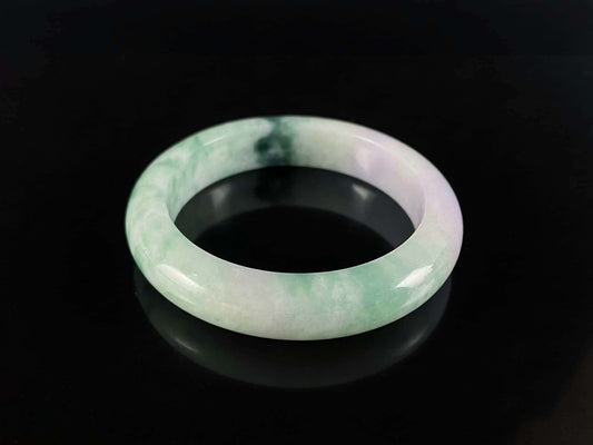 A soft lavender with green swirl jadeite bangle.