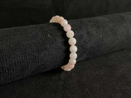 A warm peach tone jadeite beads bracelet.