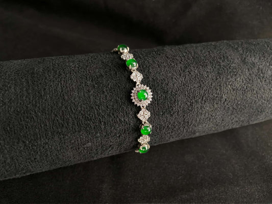 A green sunburst halo jadeite bracelet.