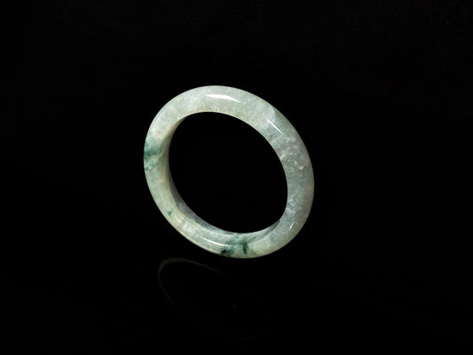 A misty cloud floral green jadeite bangle.
