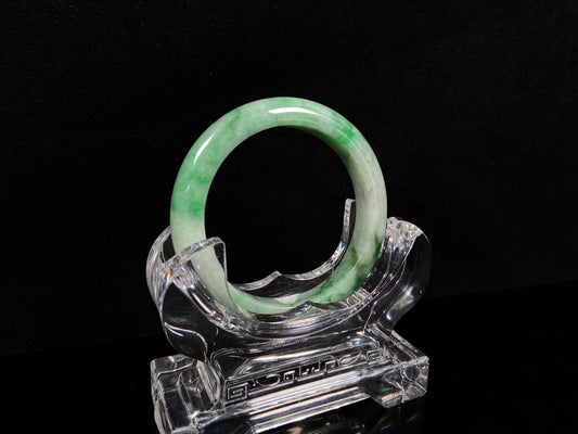 A soft white with fresh green streaks
jadeite bangle.