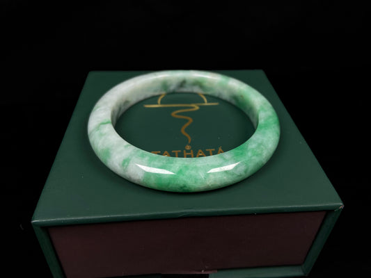 A green white jadeite bangle.
