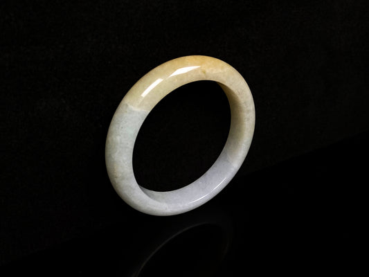 A creamy gold veil jadeite bangle.