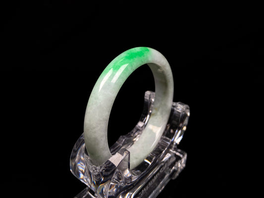 A white base with sunlit green jadeite bangle.