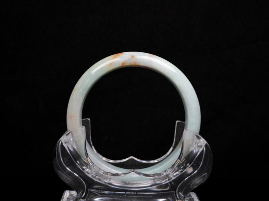 A coral glow veil jadeite bangle.