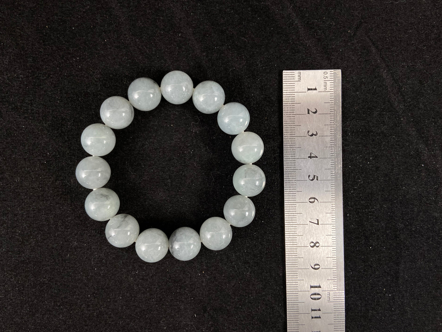 A strand of semi transparent grayish white jade beads.