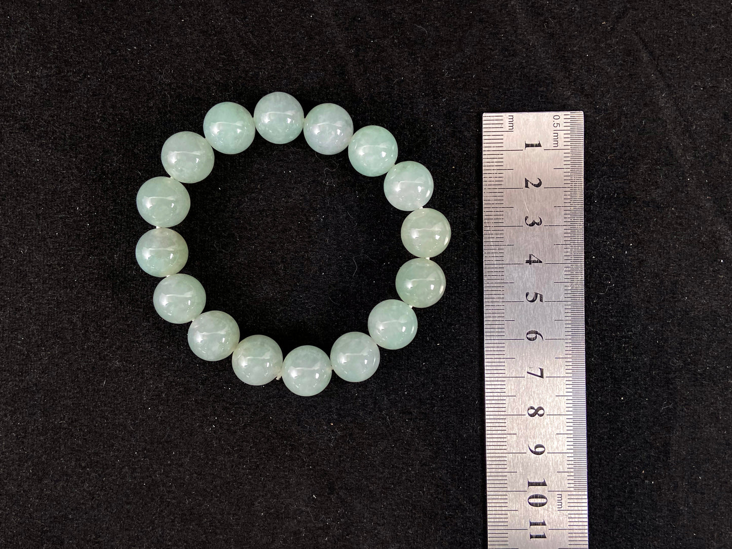 A strand of uniform pale green jade beads.