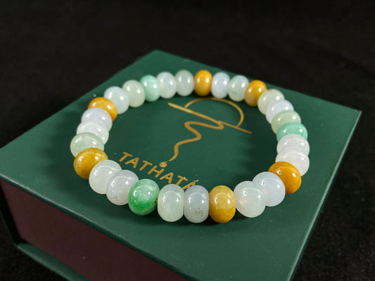 A jade bead strand featuring green, brown, yellow, white, and icy toned beads.