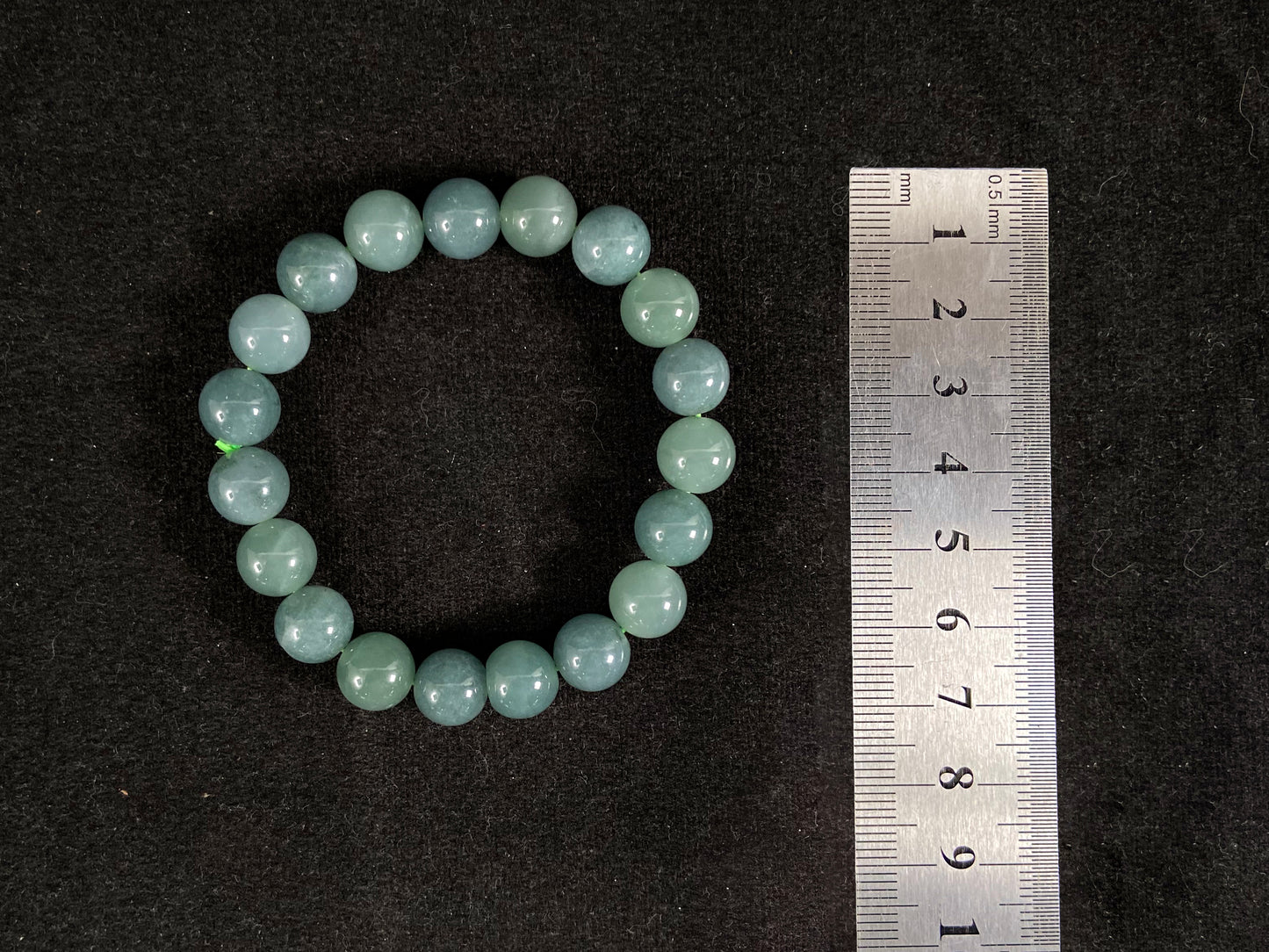 This jadeite bead strand has uniformly sized beads, including translucent pale green ones and opaque green ones.