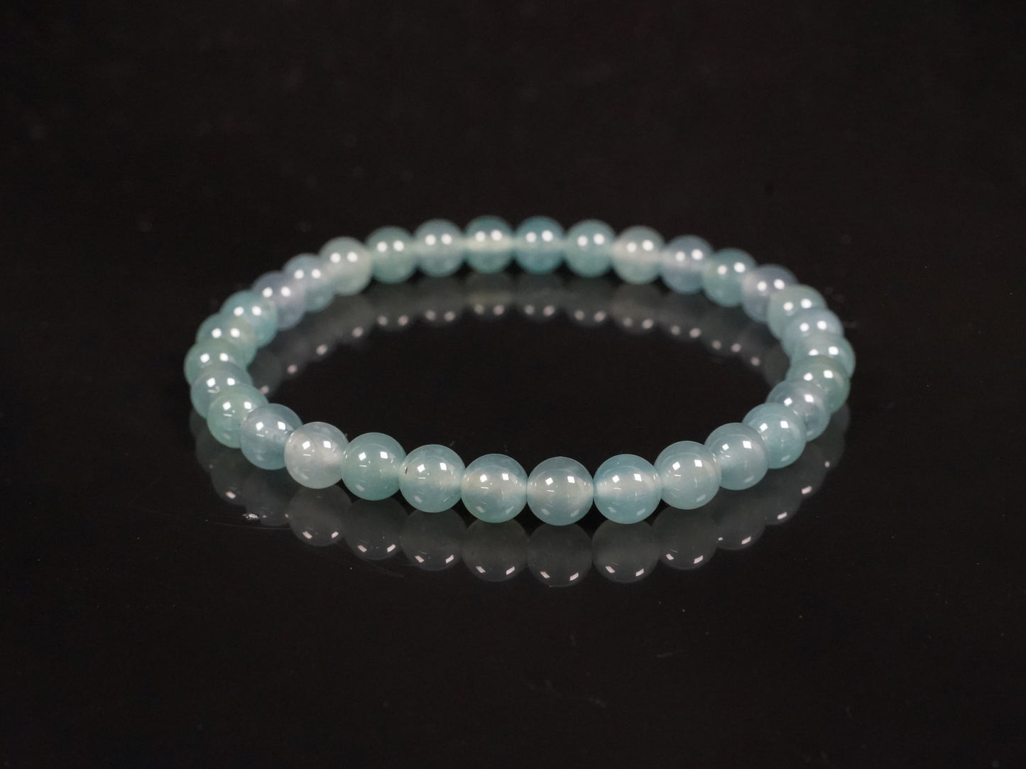 This is a pale lake-blue jadeite bracelet.