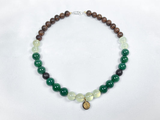 A necklace crafted from brown agarwood, green Hetian jade and yellow citrine beads.