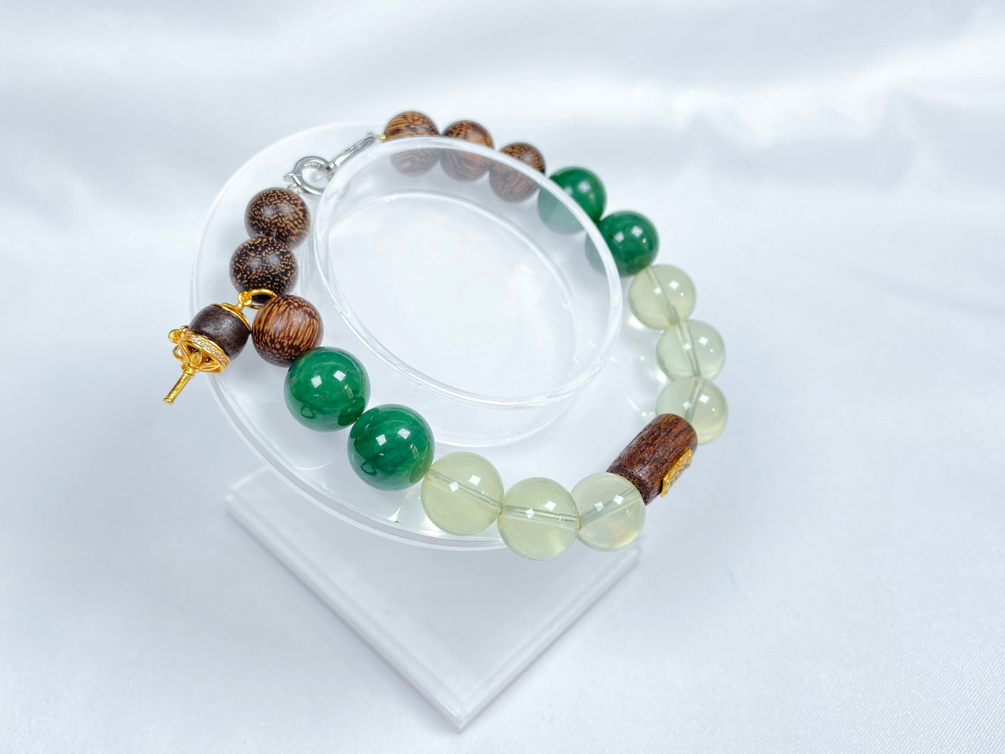 A bracelet crafted from brown agarwood, green Hetian jade and yellow citrine beads.