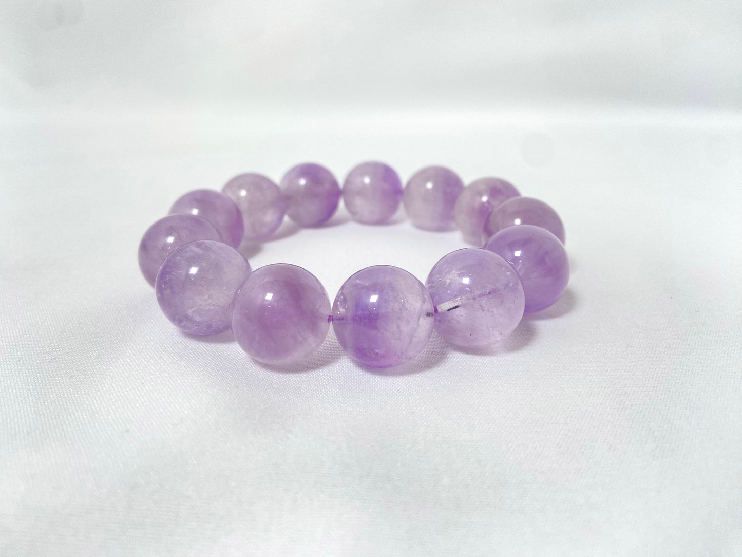 Amethyst crystal beads hand strung on an elastic cord.