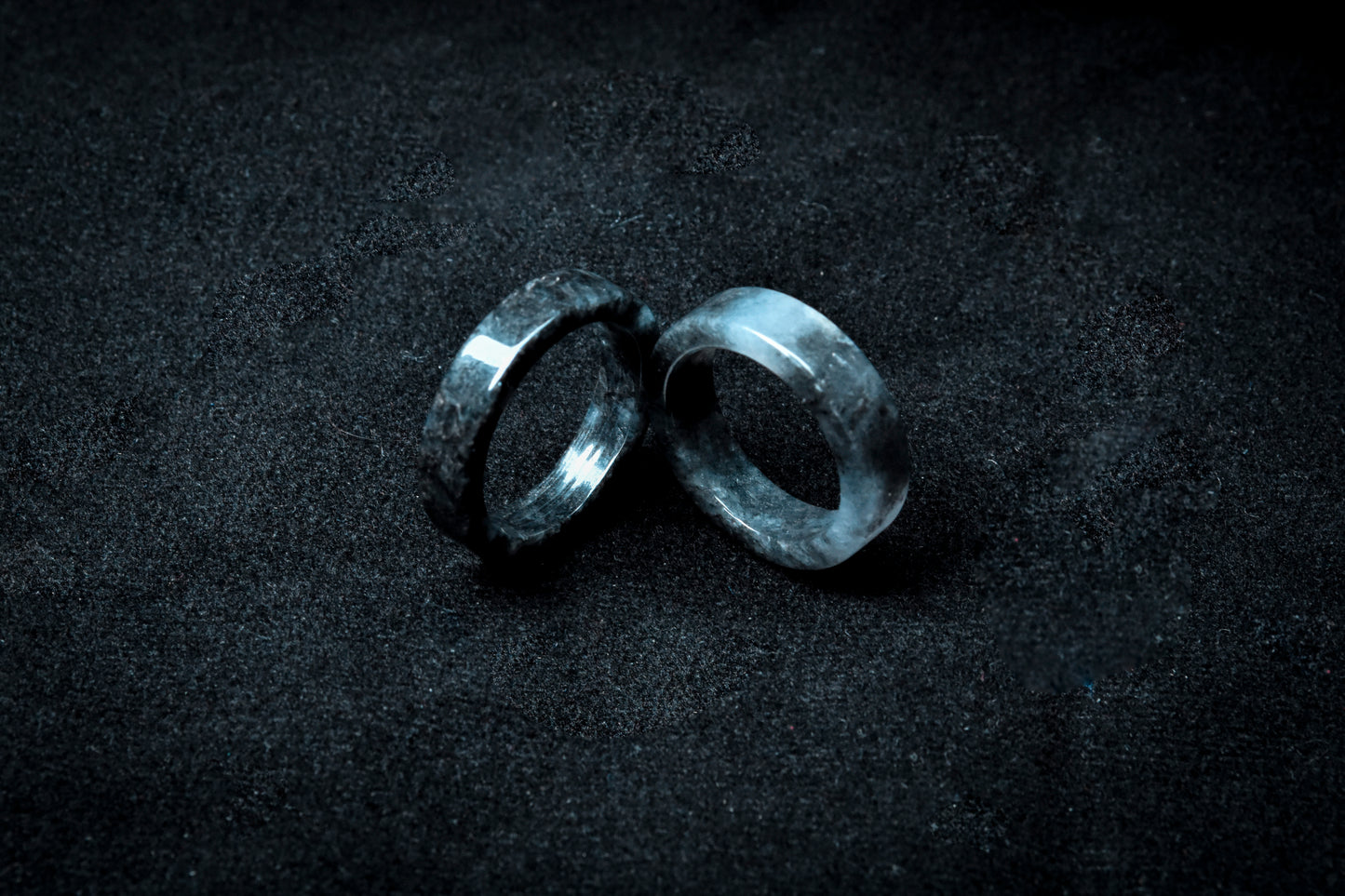 Two metallic rings on a dark textured surface