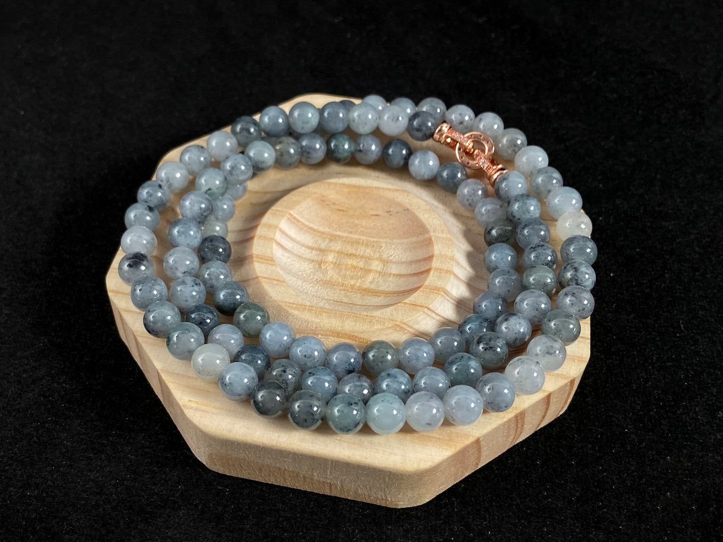 A jade bead strand composed of small pale gray beads.