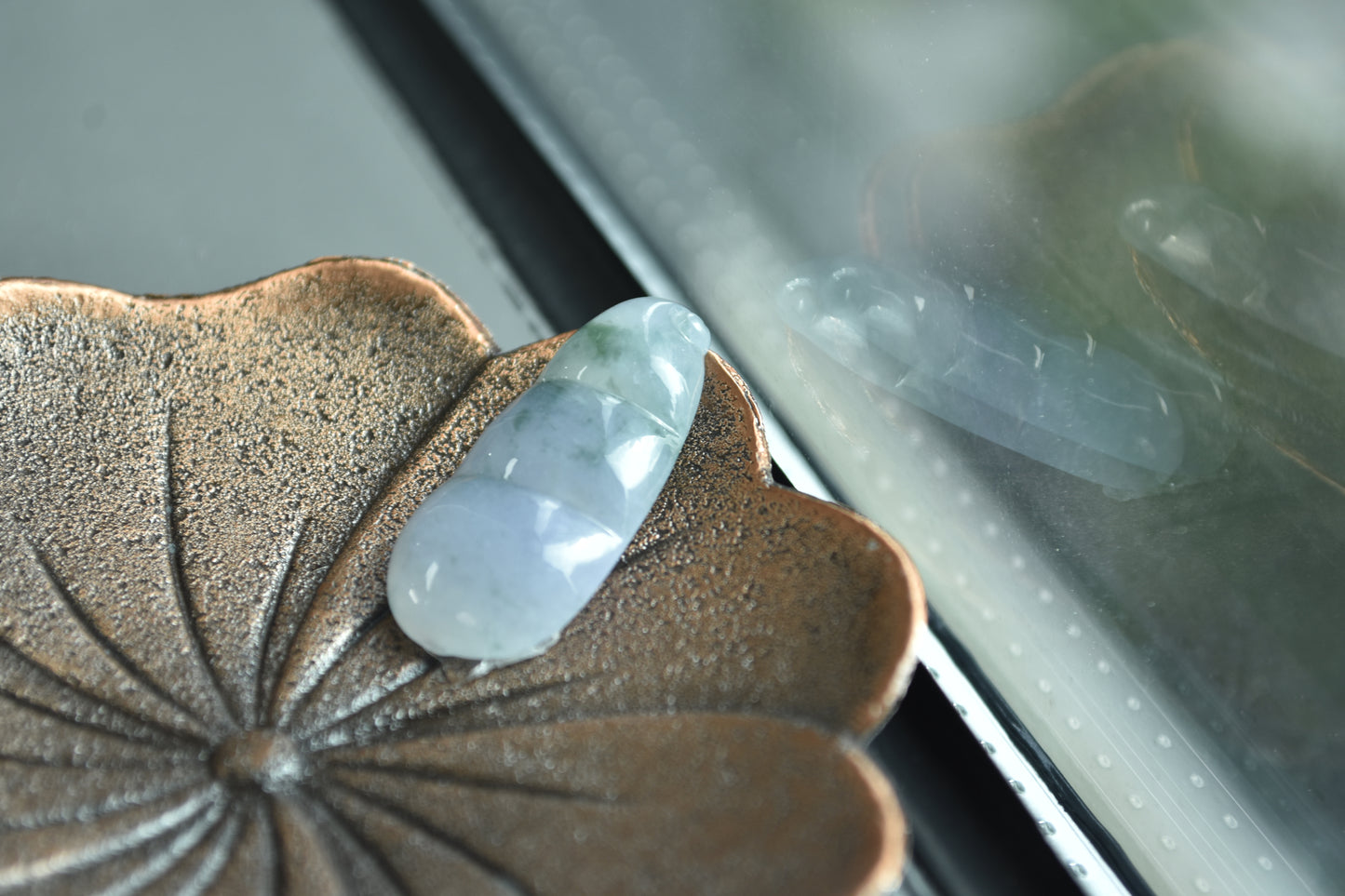Clear crystal on a textured brown leaf with a blurred background