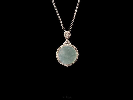 A mint dew disk jadeite pendant.