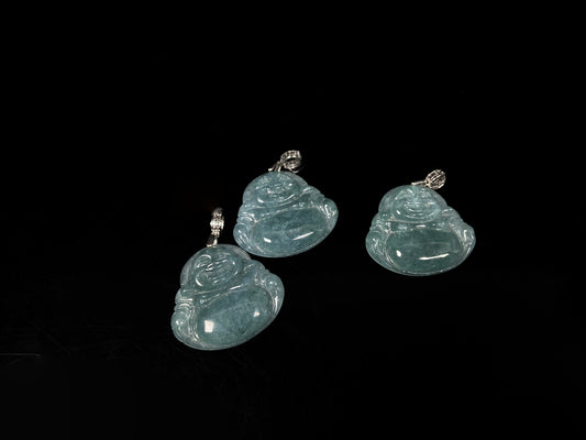 A glacial blue green Buddha jadeite pendant group.