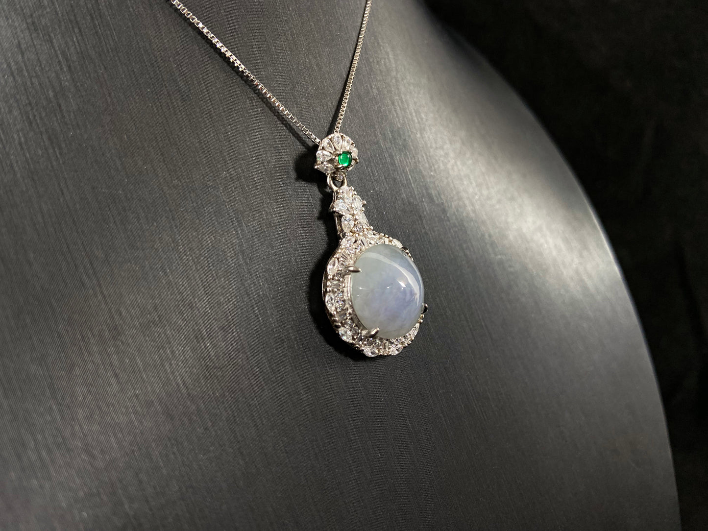 A semi transparent, pale lavender jade bead is elegantly encircled by a 925  silver frame.