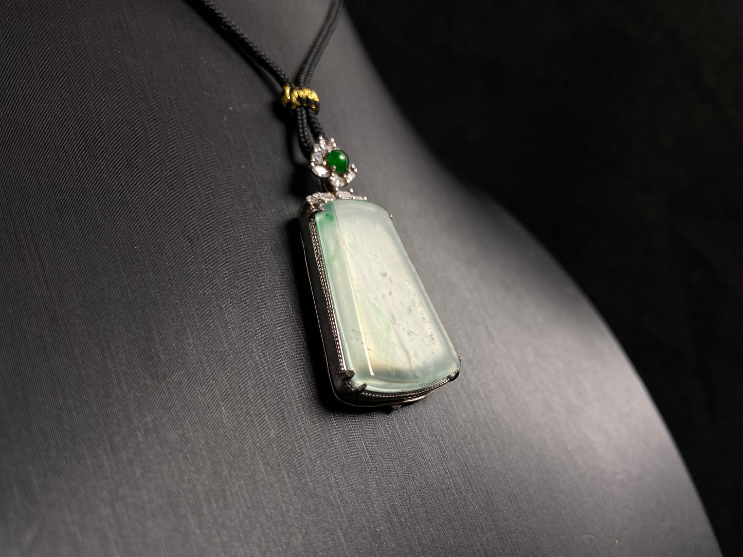 A clear light green "Wu Shi" plaque pendant, framed in 925 silver.
