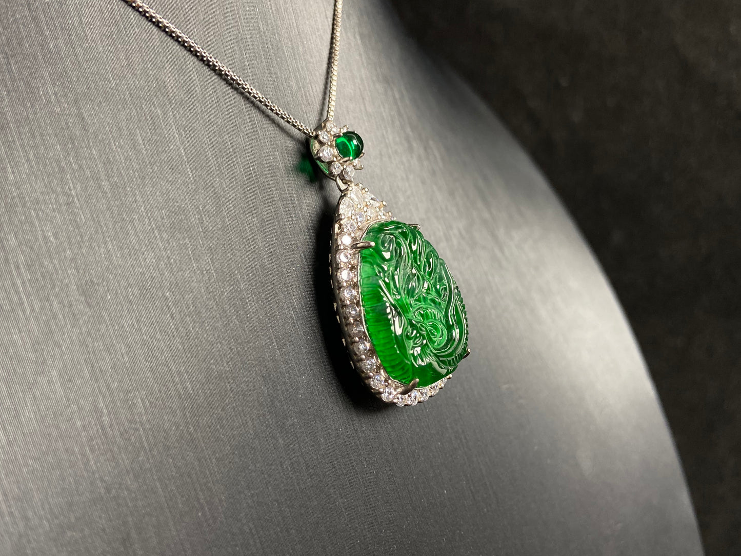 A green jade phoenix, symbolizing good fortune and prosperity, elegantly set in 925 silver.
