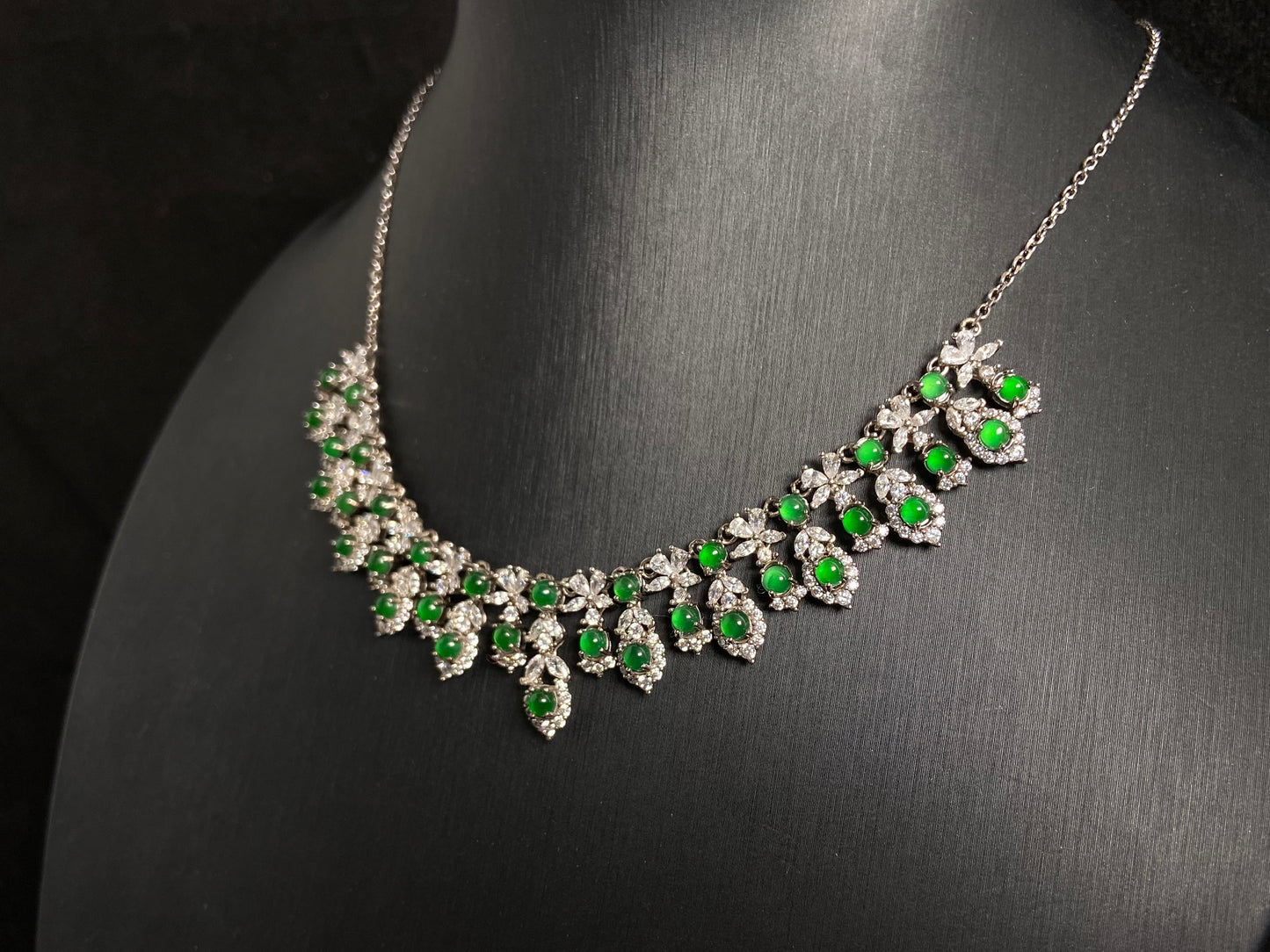 A fox shaped pendant featuring 34 imperial green translucent jade beads with 925 silver petal and leaf accents.