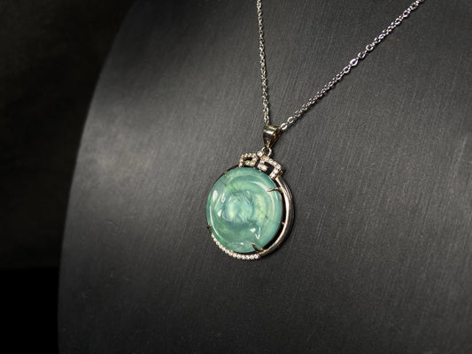 A jelly green twin fish jadeite pendant.