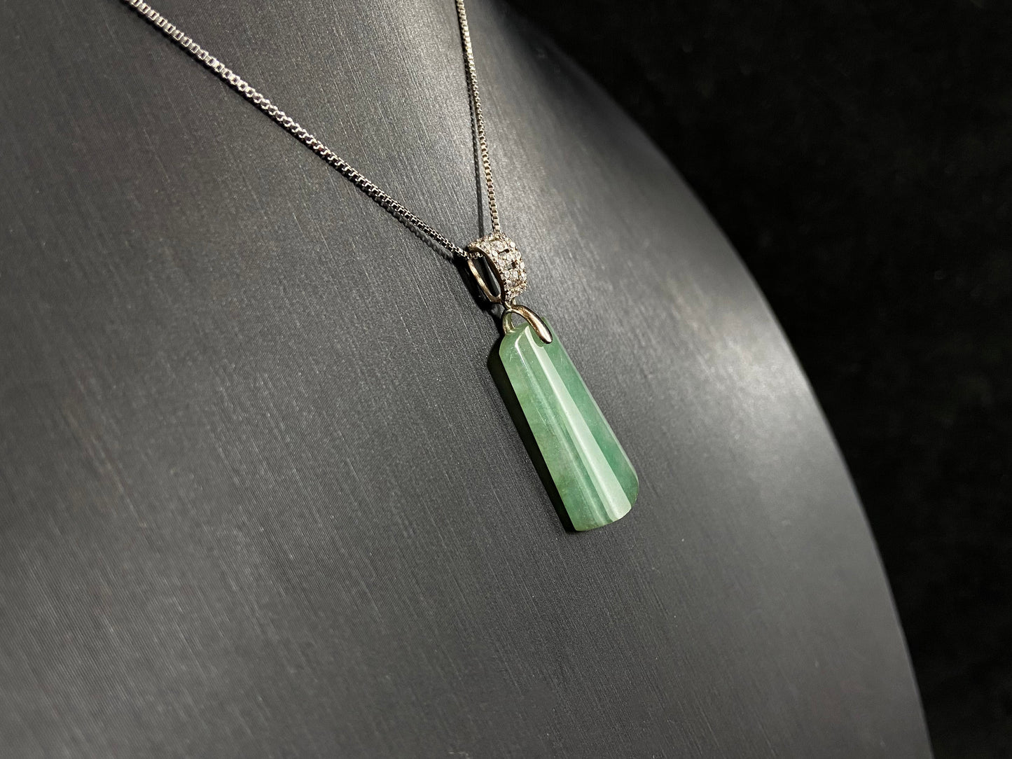 This jade pendant is a peace plaque with a green base.