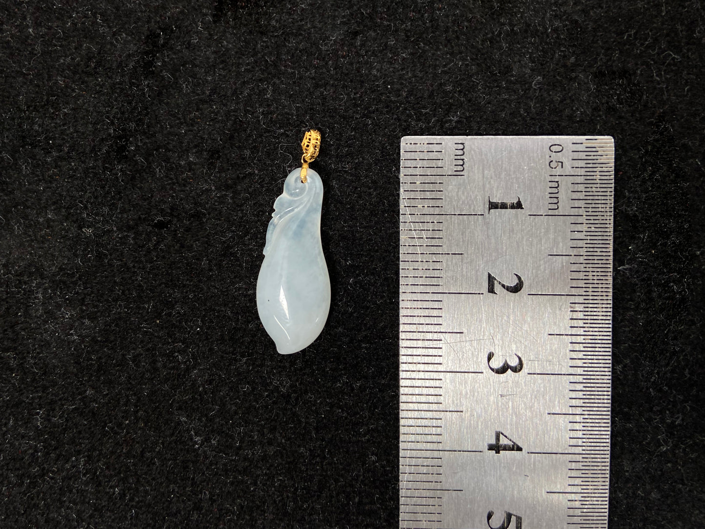 A milky white jadeite eggplant pendant.