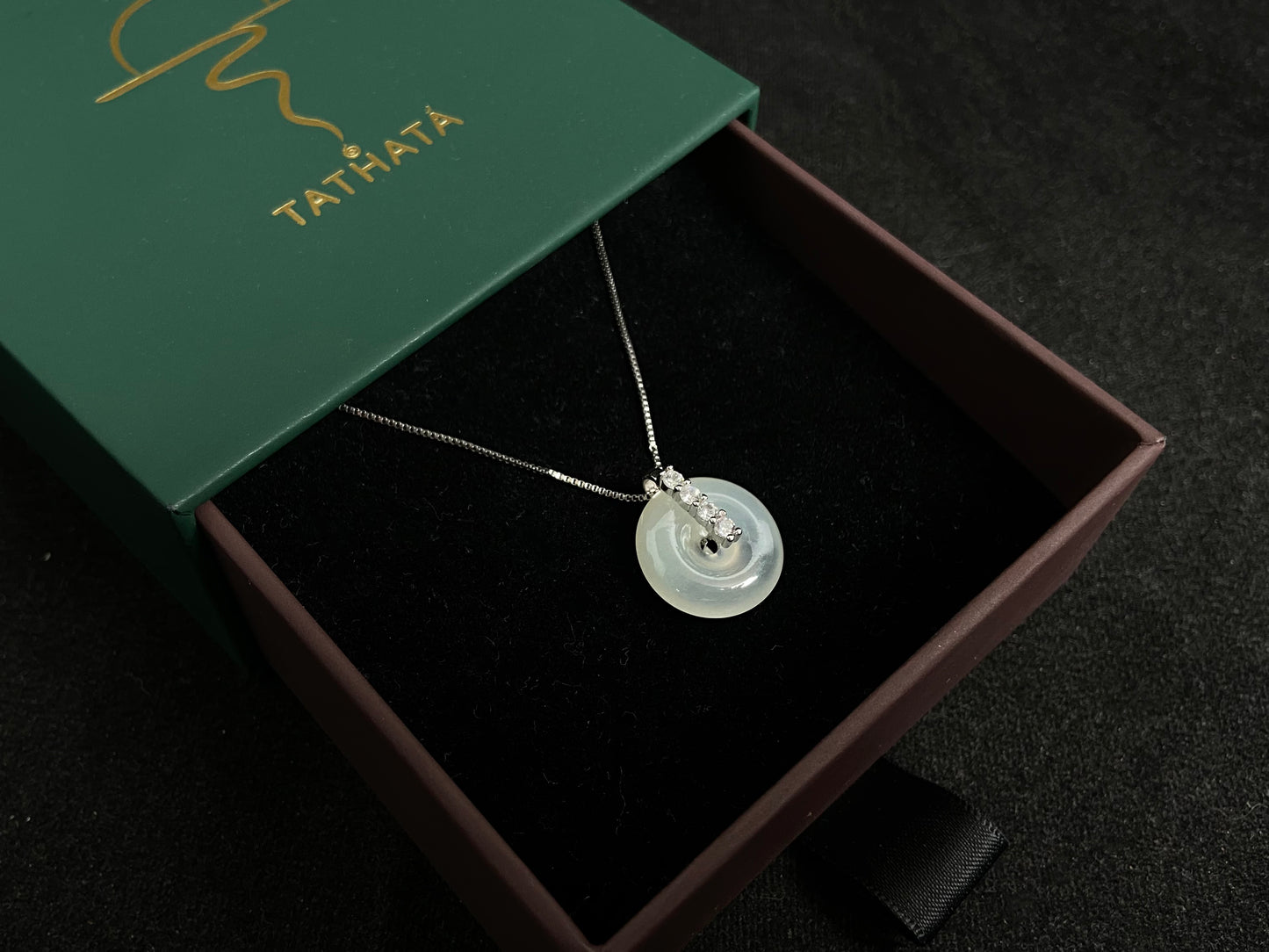 A serene icy clear jade circle pendant, embodying lifelong harmony and peace in its graceful form.