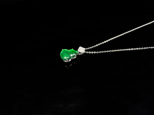 A diamond floral green hulu jadeite pendant.