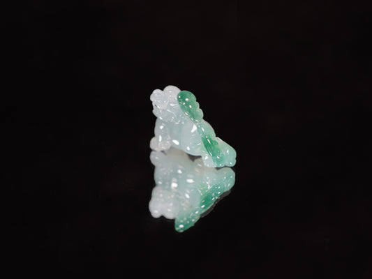 A translucent base green Pixiu loose jadeite.