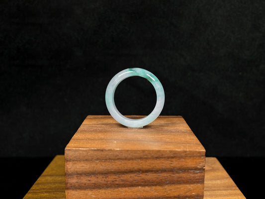 A milky white with green veins jadeite ring.