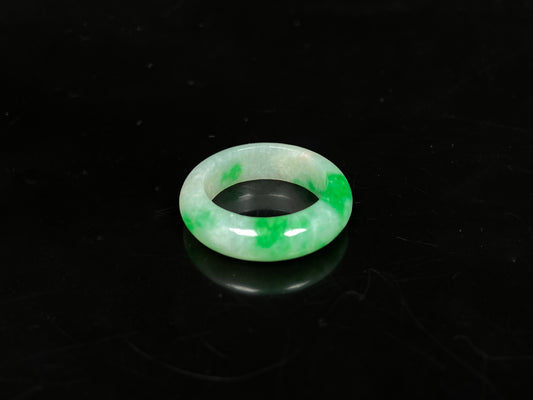 A lush green patch on white jadeite ring.