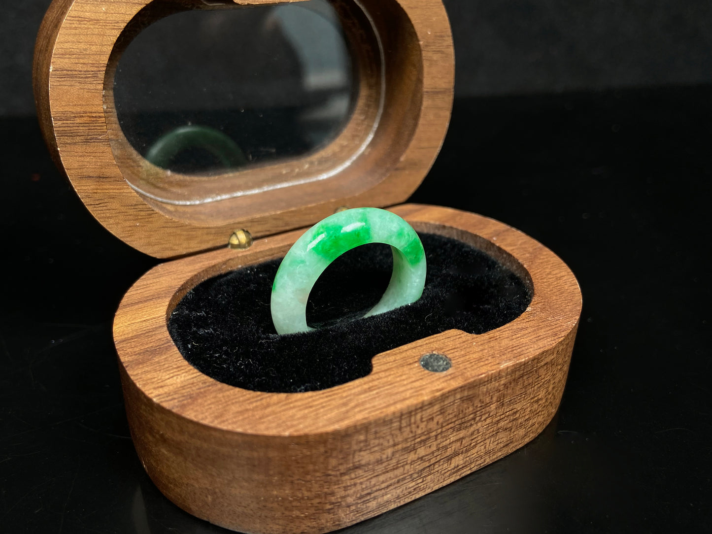 A lush green patch on white jadeite ring.