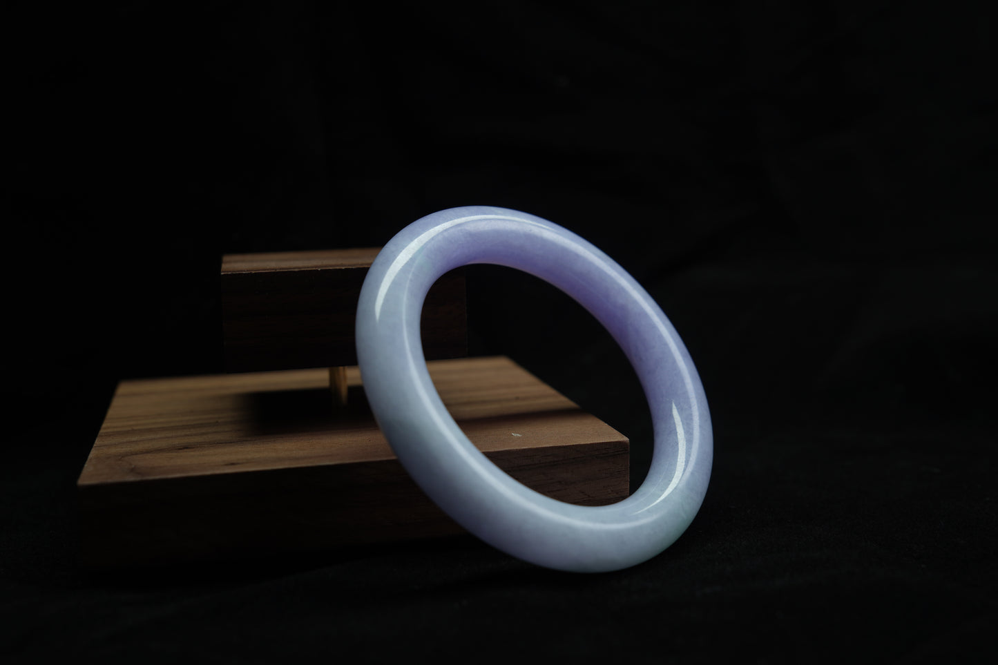 Violet jadeite round bangle on wooden display block