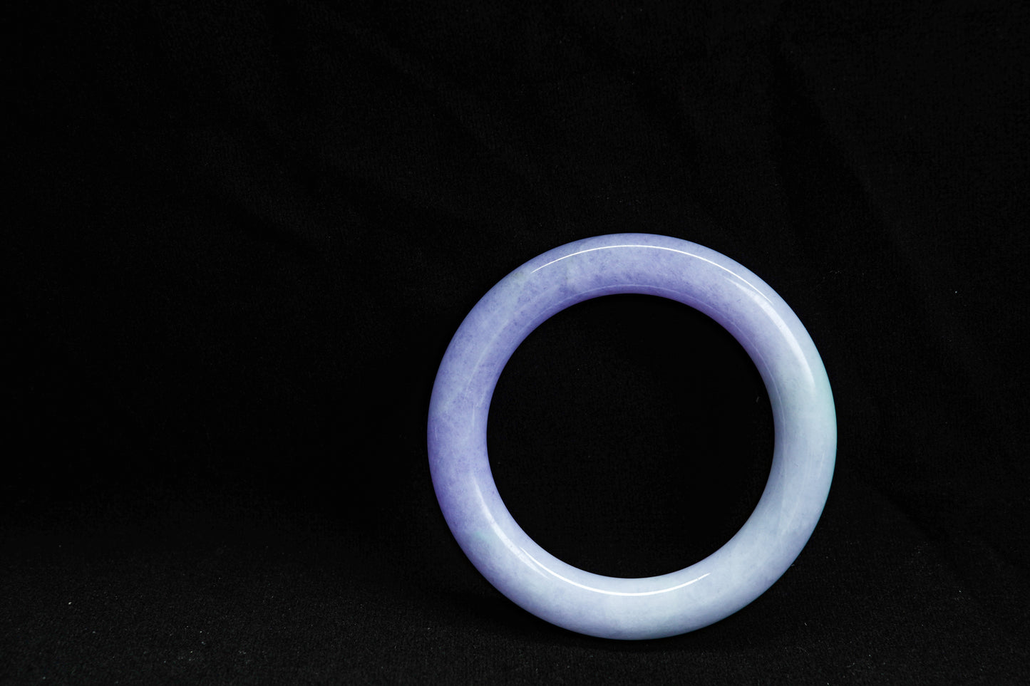 Purple jade bracelet on a black background