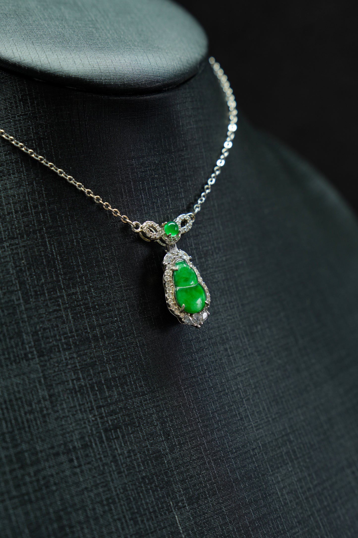 Necklace with a green pendant on a dark background