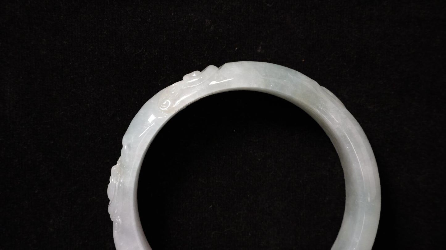 A ivory mist carving jadeite bangle.