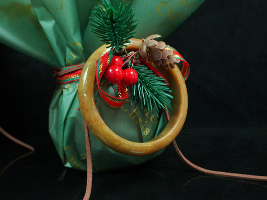 A auburn tinged golden caramel jadeite bangle.