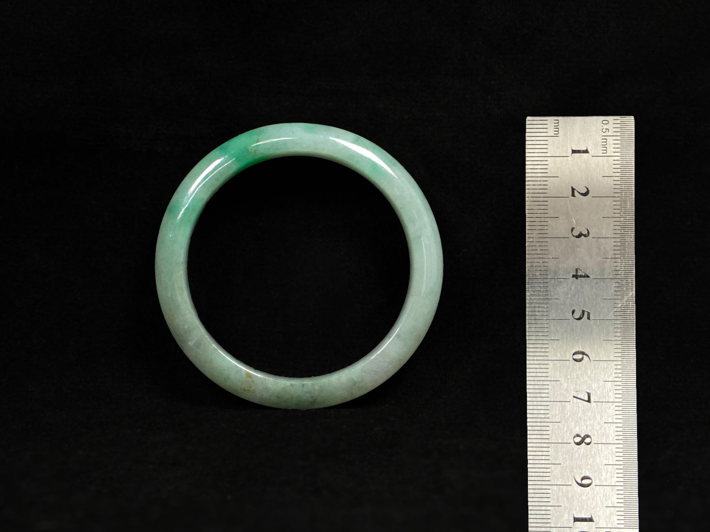 A misty green base, graced with floating deep green accents and a whisper of grey.