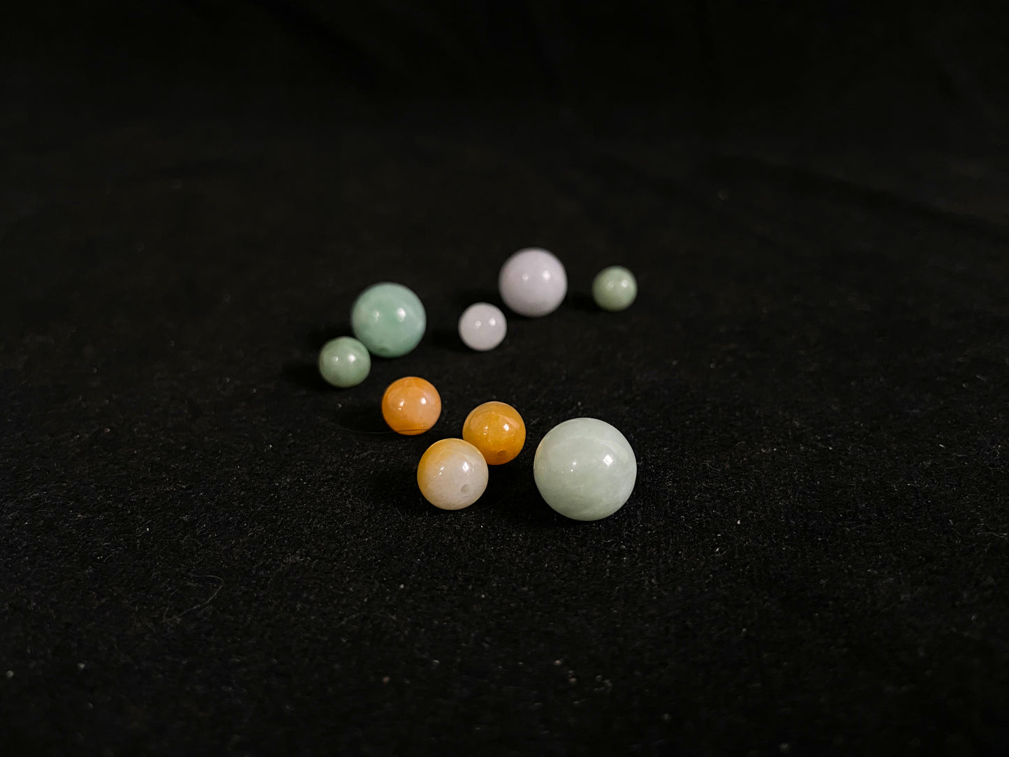 Assorted colored beads on a black background