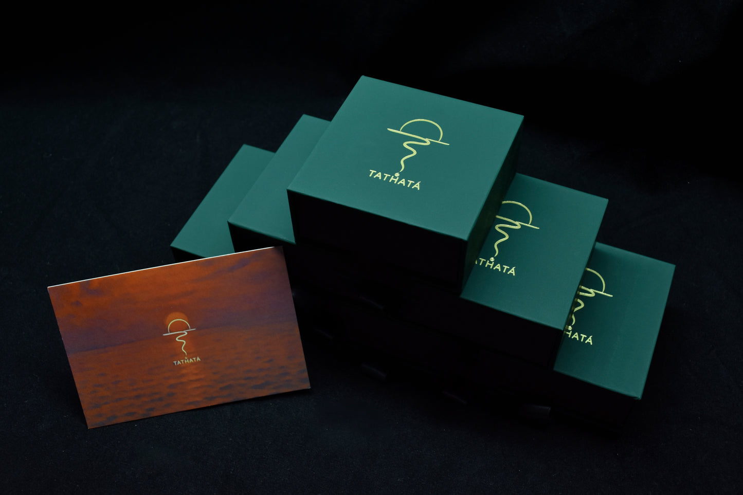 Green and brown boxes with a logo on a dark background