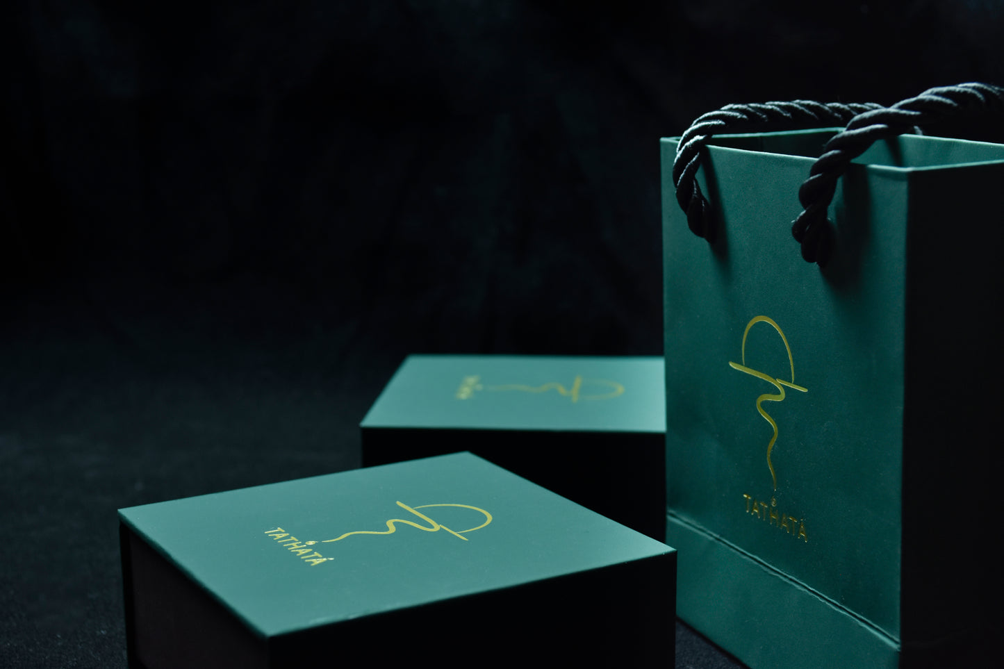 Green packaging with a logo on a dark background
