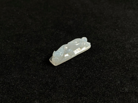 This jadeite is carved into a dragon motif in semi-transparent, milky white jade.