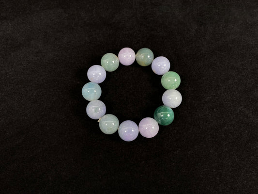 A beaded jadeite bracelet featuring purple, blue, light green, and dark green.